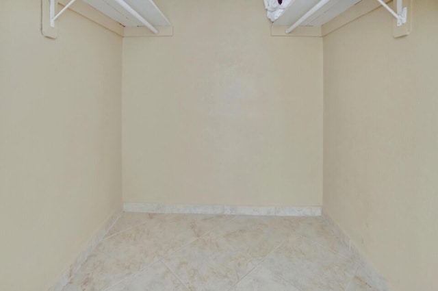 walk in closet featuring tile patterned flooring