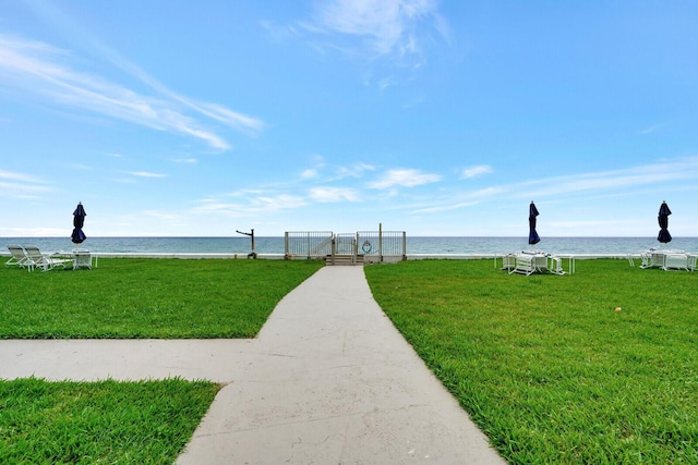 view of community featuring a yard and a water view