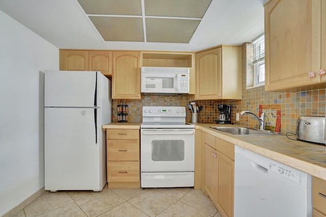 kitchen featuring white appliances, sink, and light brown cabinets