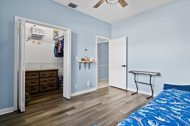 bedroom featuring wood-type flooring, ceiling fan, and a closet