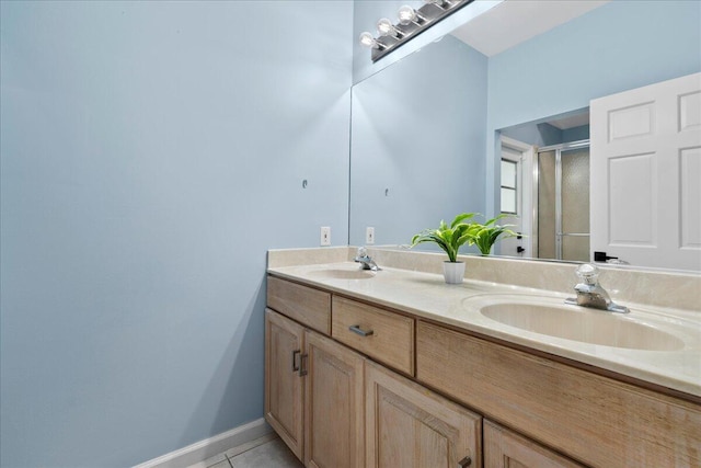 bathroom featuring vanity, an enclosed shower, and tile patterned flooring