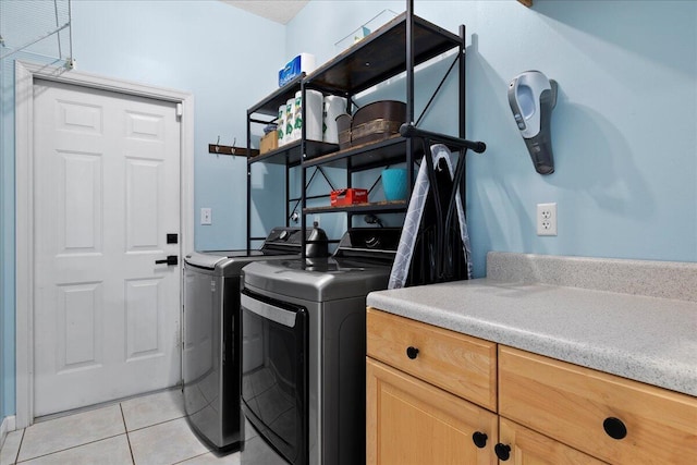 laundry area featuring separate washer and dryer and light tile patterned flooring