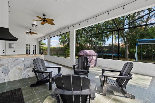 view of patio / terrace with a trampoline, ceiling fan, and french doors