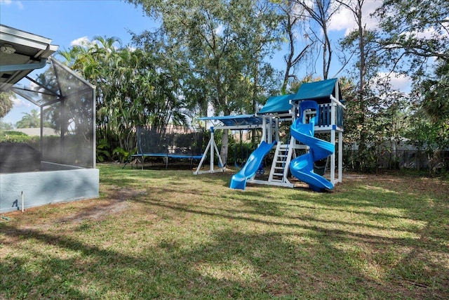 view of jungle gym featuring a trampoline and a lawn