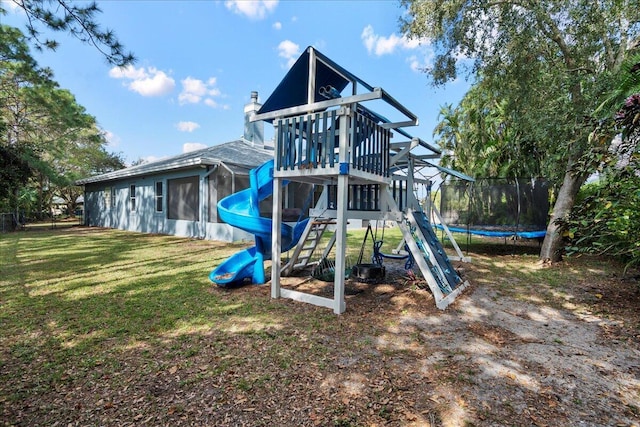 view of play area with a trampoline and a yard