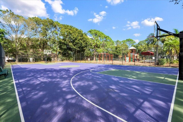 view of sport court featuring a playground