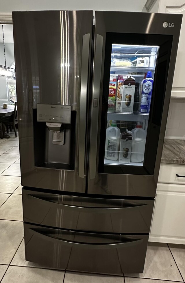 kitchen with stainless steel dishwasher and white cabinets