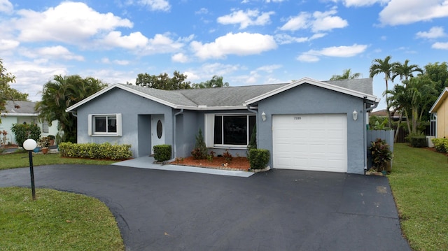 ranch-style house featuring a garage and a front yard