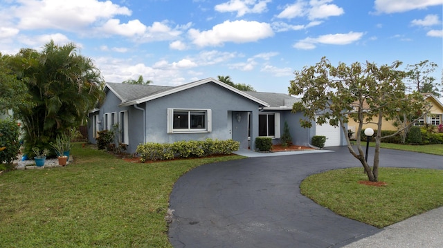 ranch-style home featuring a garage and a front lawn