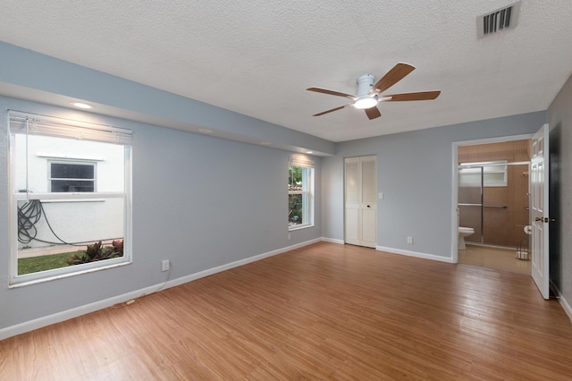 unfurnished room featuring wood-type flooring, ceiling fan, and a textured ceiling