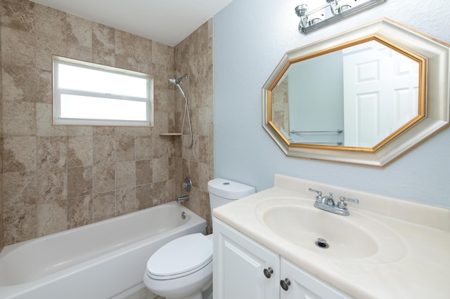 full bathroom with vanity, toilet, and tiled shower / bath