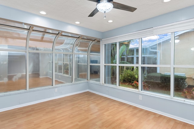 unfurnished sunroom with a wealth of natural light and ceiling fan