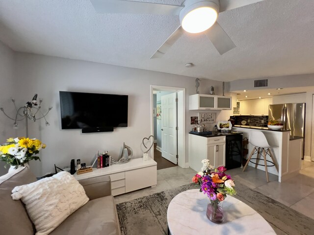 bedroom with ceiling fan and a textured ceiling