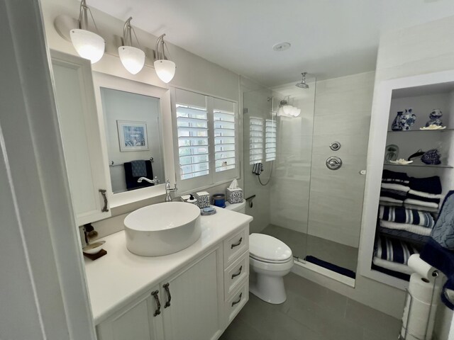 kitchen with pendant lighting, light tile patterned floors, white cabinetry, and stainless steel appliances