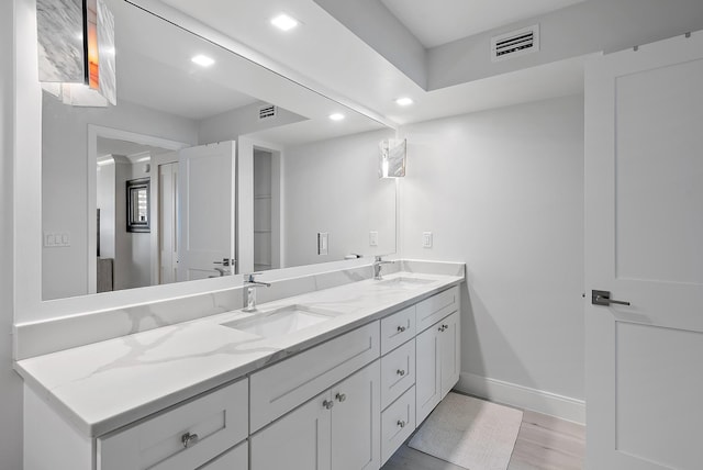 bathroom featuring hardwood / wood-style flooring and vanity