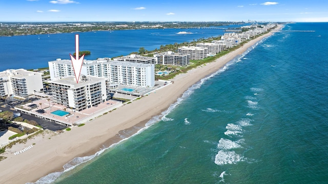 bird's eye view featuring a water view and a beach view