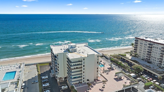 birds eye view of property with a water view and a view of the beach