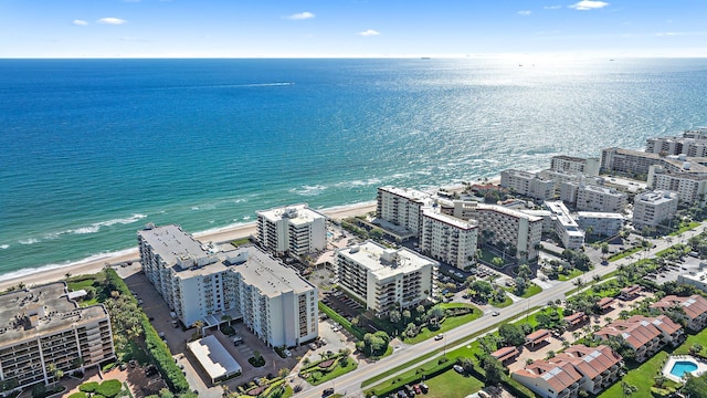 drone / aerial view featuring a water view and a view of the beach