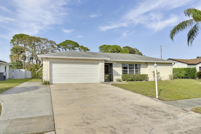 ranch-style home with a garage, a front yard, and central AC unit