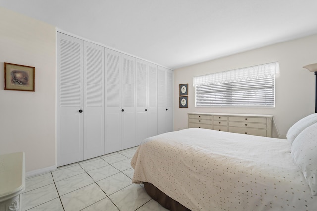 tiled bedroom featuring a closet