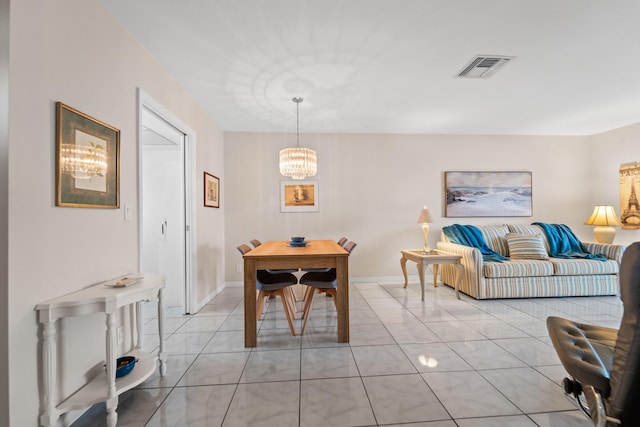 dining space featuring an inviting chandelier and light tile patterned flooring