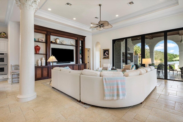 living room featuring decorative columns, stone tile flooring, arched walkways, and visible vents