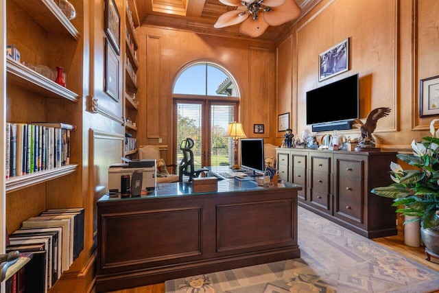 office area featuring wood walls, ceiling fan, ornamental molding, beam ceiling, and coffered ceiling