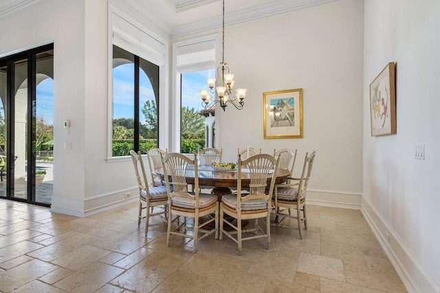 dining room with ornamental molding and a chandelier