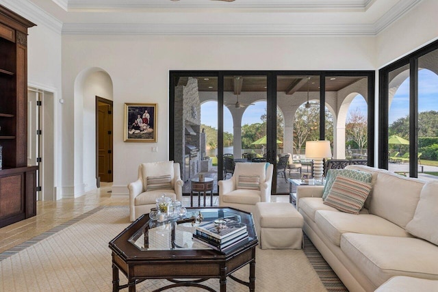 living room featuring ornamental molding and a high ceiling