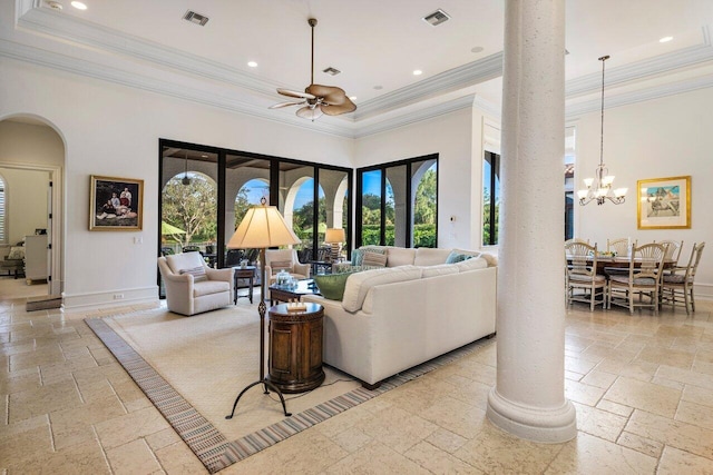 living room with a high ceiling, crown molding, ceiling fan with notable chandelier, and decorative columns