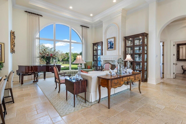 living room with arched walkways, a high ceiling, crown molding, and stone tile floors