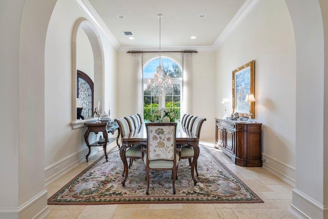 dining space with ornamental molding, arched walkways, a notable chandelier, and visible vents