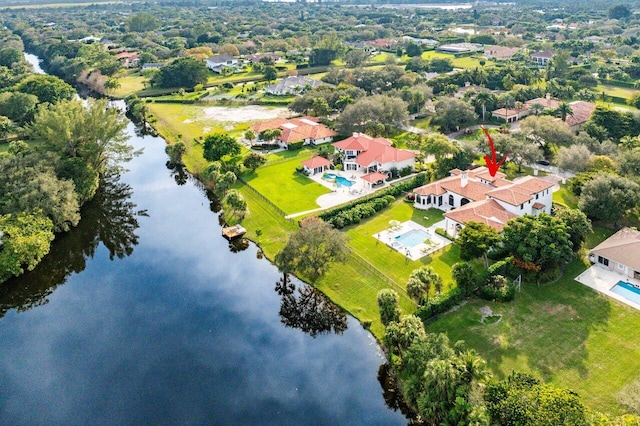 birds eye view of property with a water view and a residential view