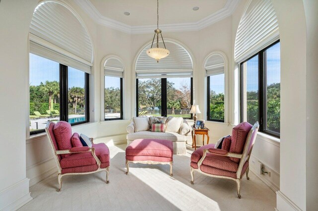 sunroom featuring baseboards, carpet, and ornamental molding