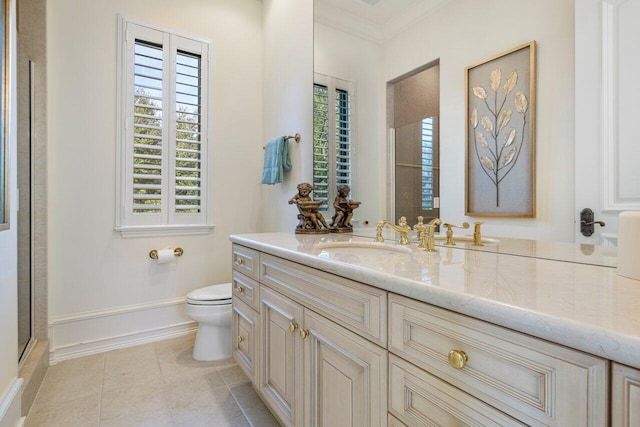 bathroom featuring tile patterned floors, crown molding, toilet, vanity, and baseboards