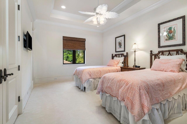 bedroom with a raised ceiling, light carpet, crown molding, and baseboards
