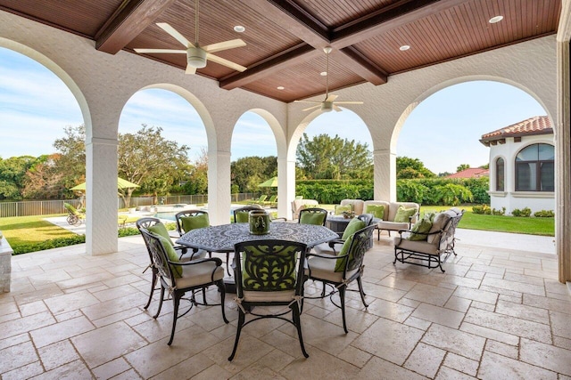 view of patio / terrace with ceiling fan, an outdoor living space, and a swimming pool