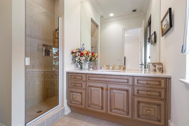 full bath featuring vanity, crown molding, tile patterned floors, a stall shower, and visible vents