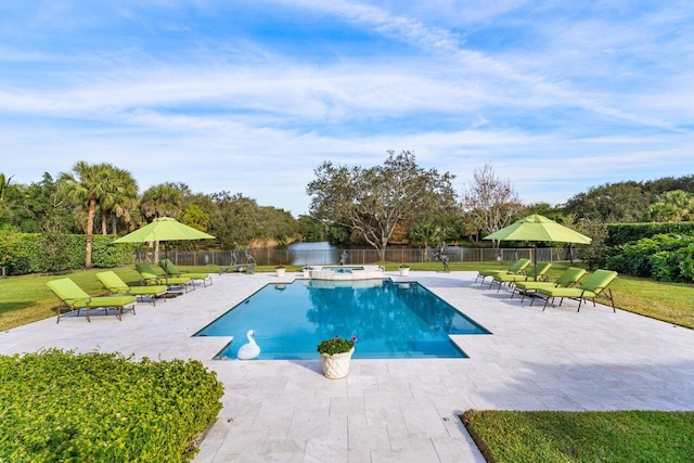 view of swimming pool with fence, a pool with connected hot tub, and a patio area