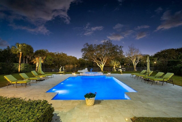 view of pool with a fenced backyard, a pool with connected hot tub, and a patio area