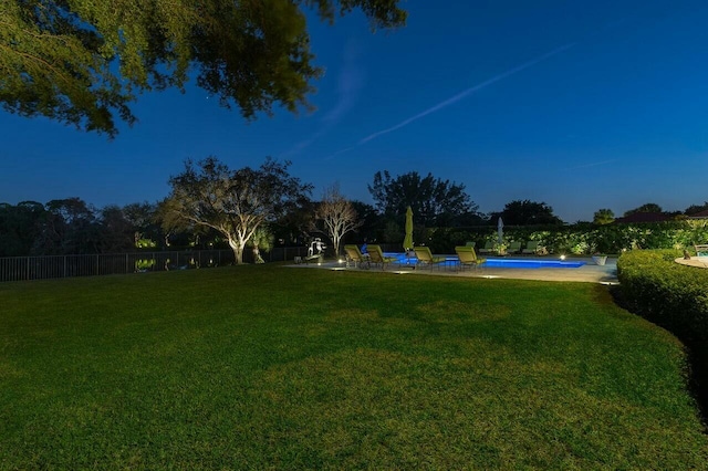 view of yard featuring a fenced in pool and fence