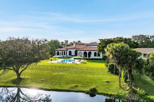 back of property with a fenced in pool, fence private yard, a yard, and a patio area