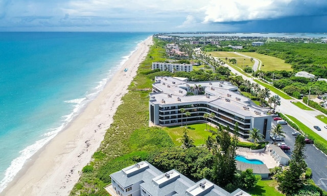 bird's eye view featuring a water view and a beach view