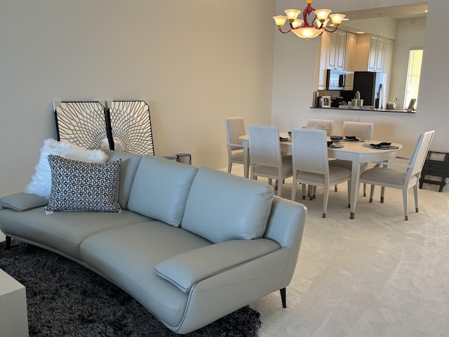 living room with a chandelier and light carpet