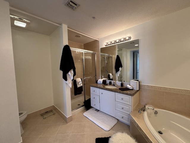 full bathroom with tile patterned flooring, vanity, separate shower and tub, and a textured ceiling