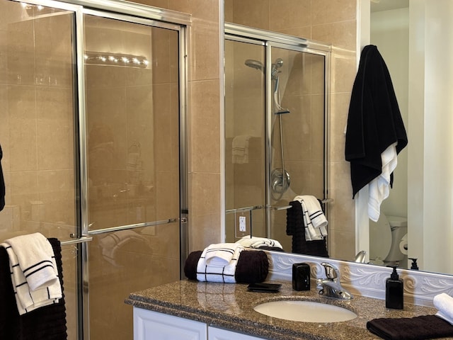 bathroom featuring vanity and a shower with shower door