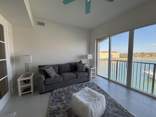 tiled living room with ceiling fan