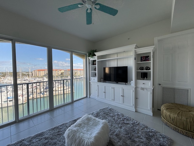 tiled living room featuring ceiling fan