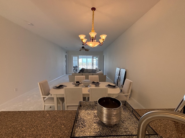 carpeted dining room with a notable chandelier