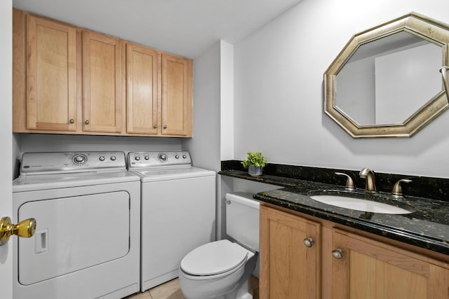 washroom featuring sink, light tile patterned floors, and washing machine and clothes dryer